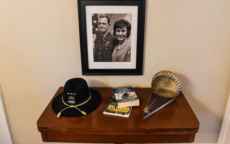 A collection of items inside the Fort Benning, Ga., commanding generals house — currently come to Maj. Gen. Curtis Buzzard — honors Lt. Gen. Hal Moore and Julia Moore, who are pictured in the photograph. Among the items are Buzzard’s copies of two of Hal Moore’s books, “We Were Soldiers Once … And Young” and “Hal Moore on Leadership.” Fort Benning later this year will be renamed Fort Moore in Hal and Julia’s honor.