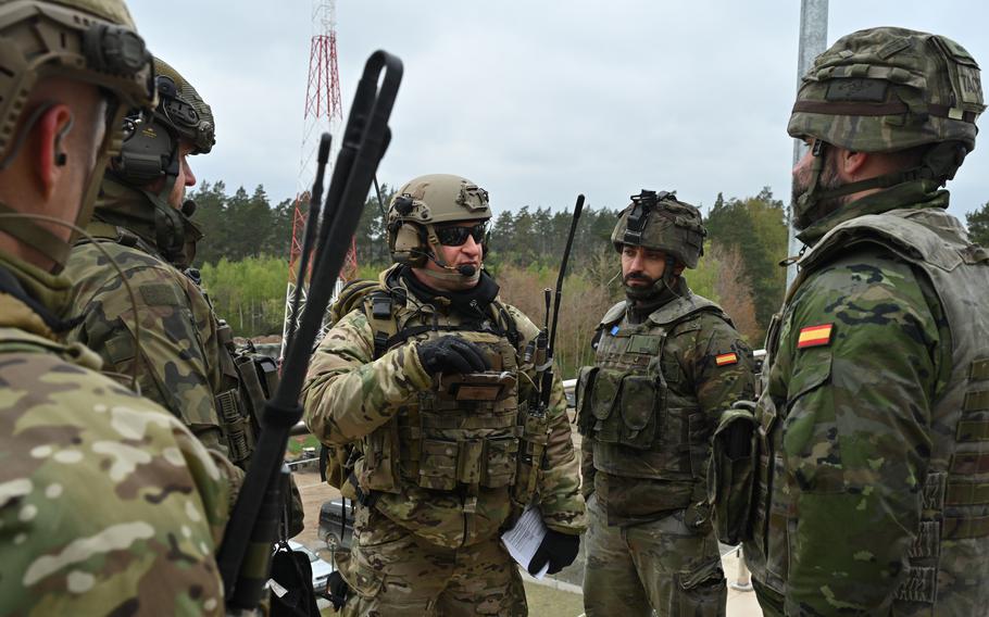 Service members from the U.S., Polish and Spanish militaries discuss operations during Saber Strike 24 at Bemowo Piskie Training Area, Poland, April 22, 2024. Finding that defense spending alone is an incomplete measure of military fitness, a recent Rand Corp. study said the Pentagon needs a new method for measuring whether countries in Europe and Asia are carrying their fair share of the security burden.