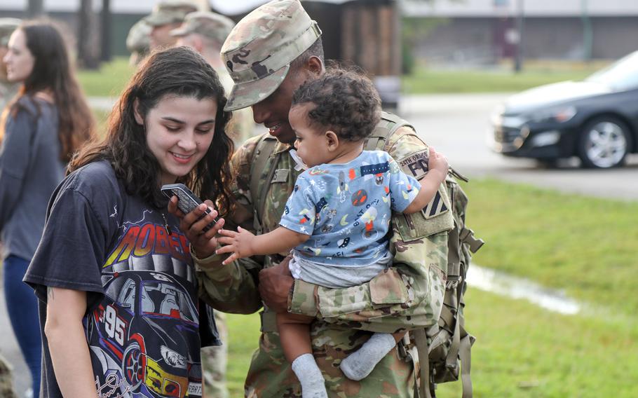 Spc. Deon Harris from the 3rd Infantry Division spends time with his family before deploying to Europe from Fort Stewart, Ga., in June 2023. The latest Blue Star Families annual survey of military life saw 32% of those polled choose “likely” in a question about willingness to recommend the military to family. That continues a decline from a high of 55% in 2016.