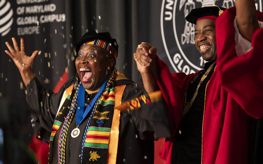 A graduate throws confetti to celebrate
