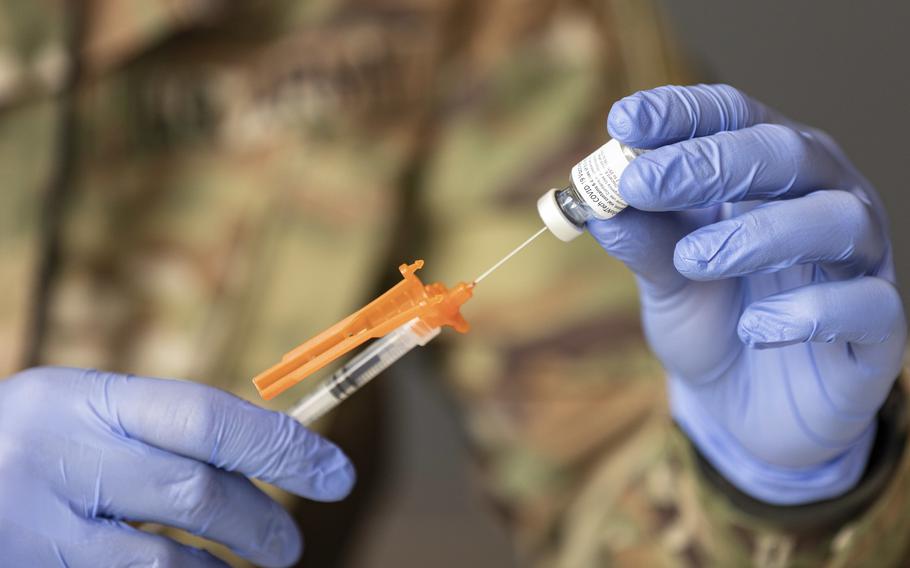 Army soldiers draw and prepare vaccines at the Atlanta Community Vaccination Center in the Mercedes-Benz Stadium in Atlanta on March 26, 2021. 