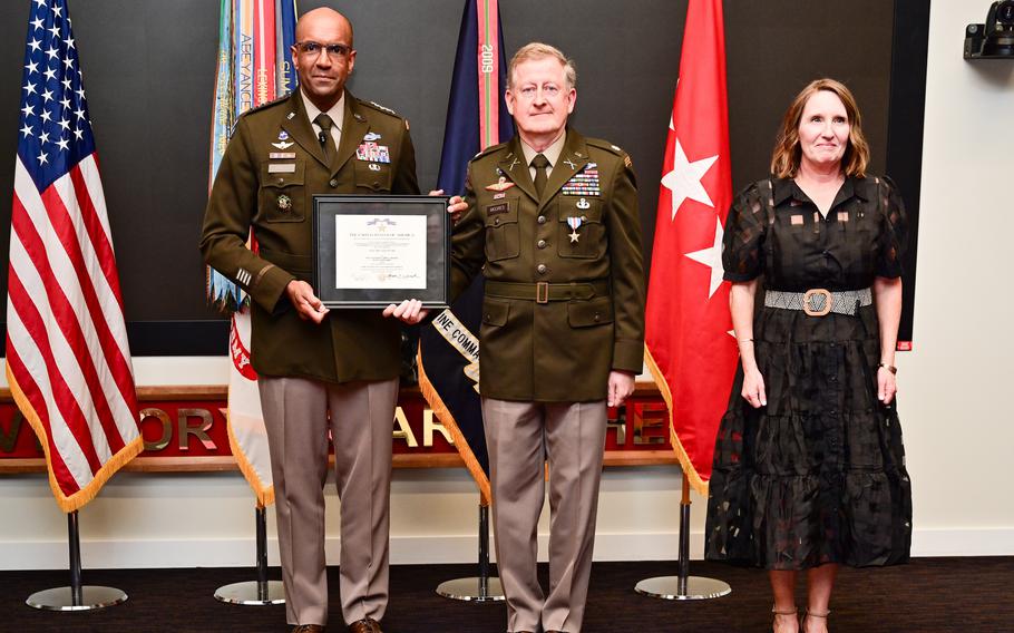 Gen. Gary Brito, commanding general, U.S. Army Training and Doctrine Command, presents retired Army Maj. Larry Moores with the Silver Star during a ceremony in front of family and friends March 25, 2024. Moores’ wife, retired Army Col. Kerry E. Moores, also stands at attention during the presentation.