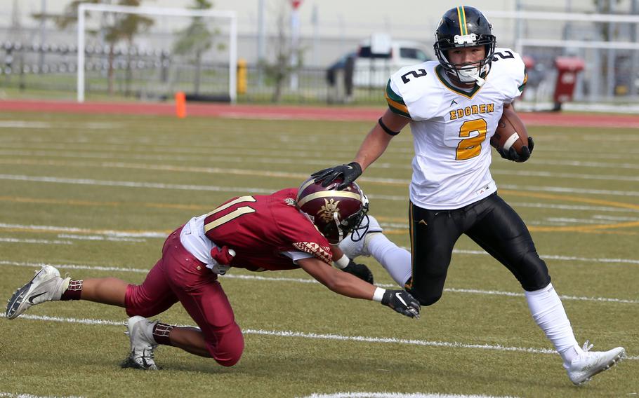 Robert D. Edgren's Aiden Larry tries to cut around left end against Matthew C. Perry's Eddie Pacleb.