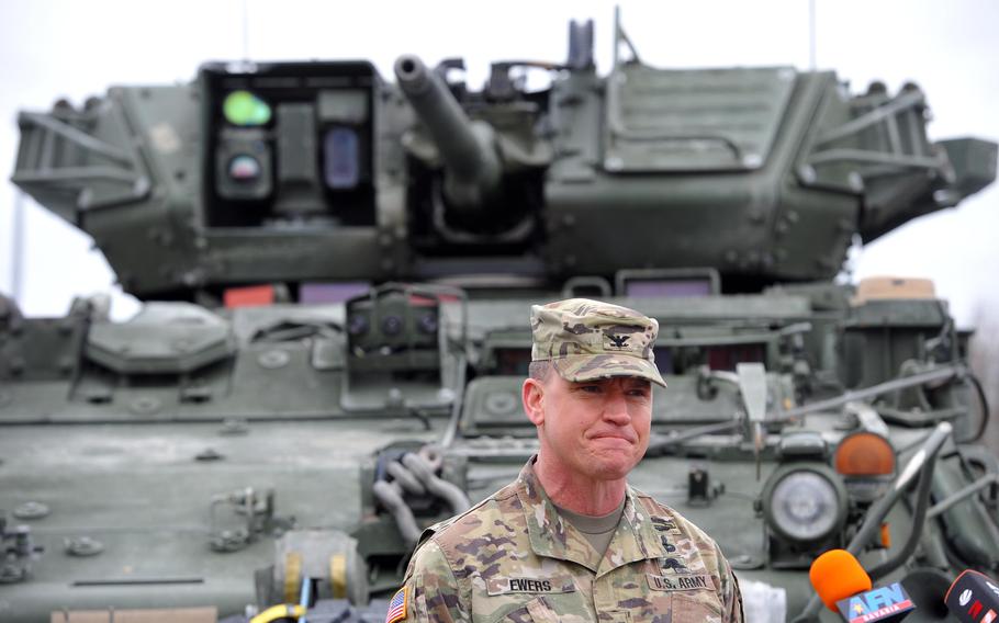 Col. Joe Ewers, commander of the 2nd Calvary Regiment, talks to the media at Vilseck Army Airfield, Germany, as his troops prepare to deploy to Romania, Feb. 9, 2022. About 1,000 soldiers are being sent to Romania to reassure allies worried about Russia. 