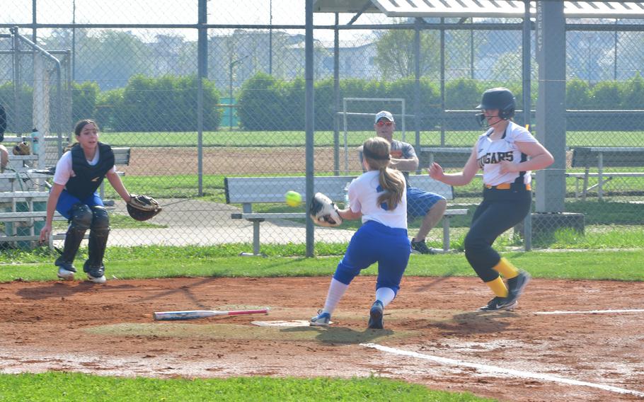 Madisyn Orlowski of the Rota Admirals tries to catch a throw from Audrey Redwine to tag Ava Henson of the Vicenza Cougars as she tries to scores during the first of two games between the teams on Caserma Del Din, Vicenza, Italy April 6, 2024. Henson beat the tag and scored the run for the Cougars. 