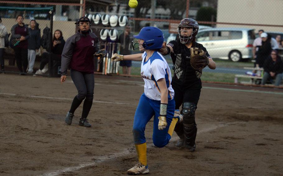 Zama catcher Evangeline Nelson throws to third base to try to catch Yokota’s Kayla Bogdan in a rundown during Tuesday’s DODEA-Japan softball game. The Panthers won 15-3.