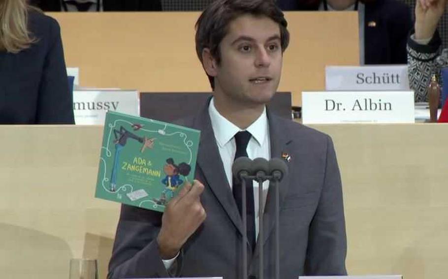 The French Minister of Education Gabriel Attal presents the book Ada & Zangemann which he offered on December 4, 2023 in Bonn to the parliamentarians of the Franco-German Parliamentary Assembly meeting in plenary session.