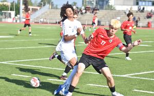 Kaiserslautern's Isaac Phillips took the ball away from Wiesbaden's Carter Edwards before the two collided Monday, May 19, 2025, at the DODEA-Europe Division I boys soccer championships in Kaiserslautern, Germany.
