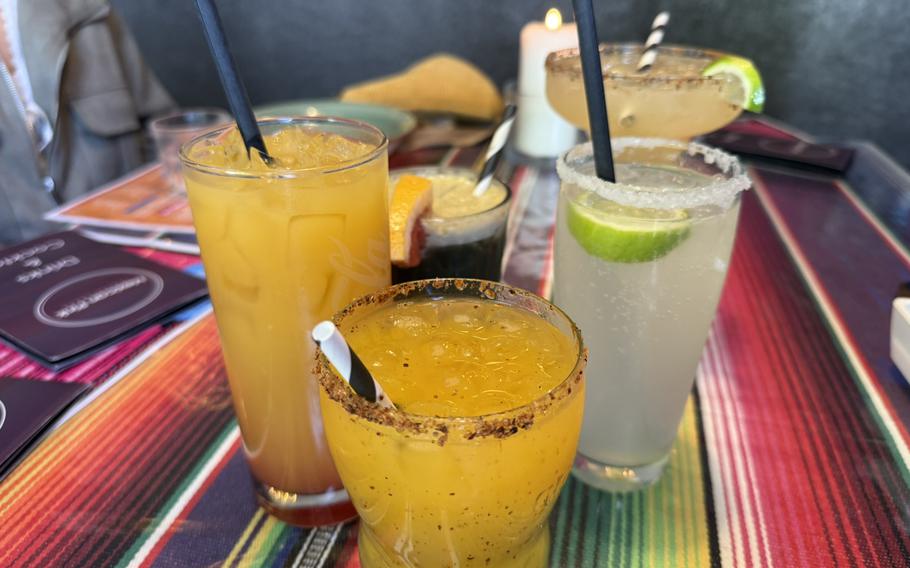Tequila- and mezcal-based cocktails sit on a table, ready to be enjoyed.
