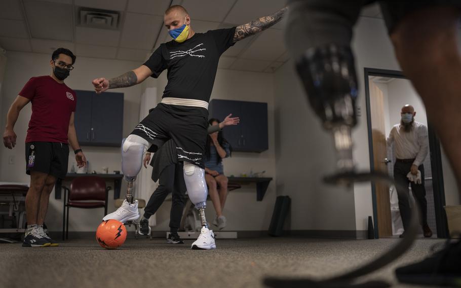 Joe Lopez, left, a physical therapy student at St. Catherine University in St. Paul, helped Daniel Sivakov, 21, of Mariupol, Ukraine, at the NovaCare Rehabilitation clinic in Crystal last week. Sivakov lost both legs in a Russian rocket attack.