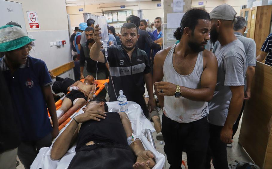 A man being rolled into a hospital.