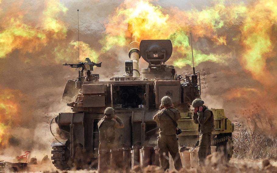 An Israeli army M109 155mm self-propelled howitzer fires rounds near the border with Gaza in southern Israel on Oct. 11, 2023.