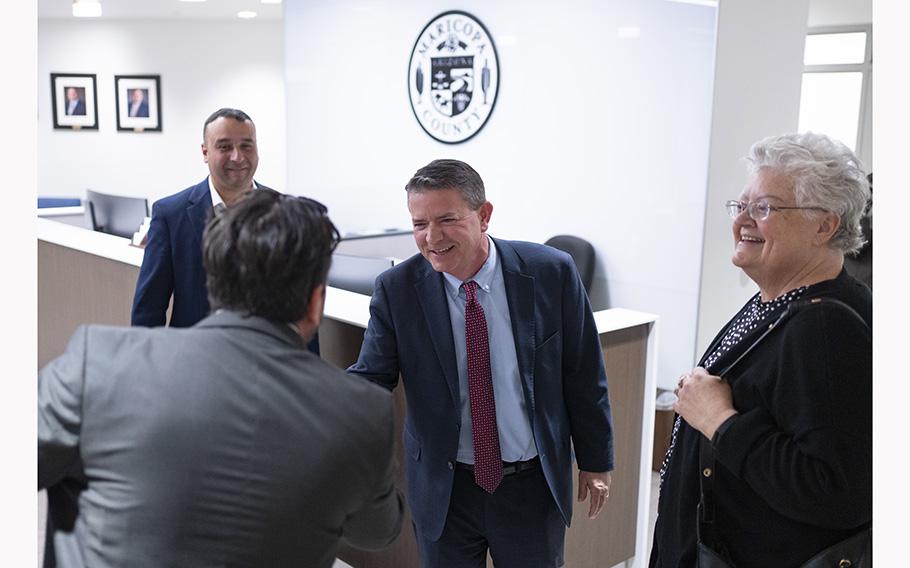 Bill Gates, center, greets Sándor Berki, a Hungarian member of Parliament, in Phoenix.