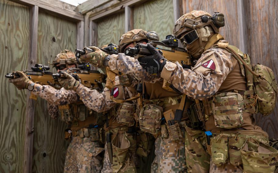 Latvian Special Forces train tactically entering bulidings in a simulated urban environment during Exercise Nothern Strike 2023 on Camp Grayling, Mich., Aug. 14, 2023. 