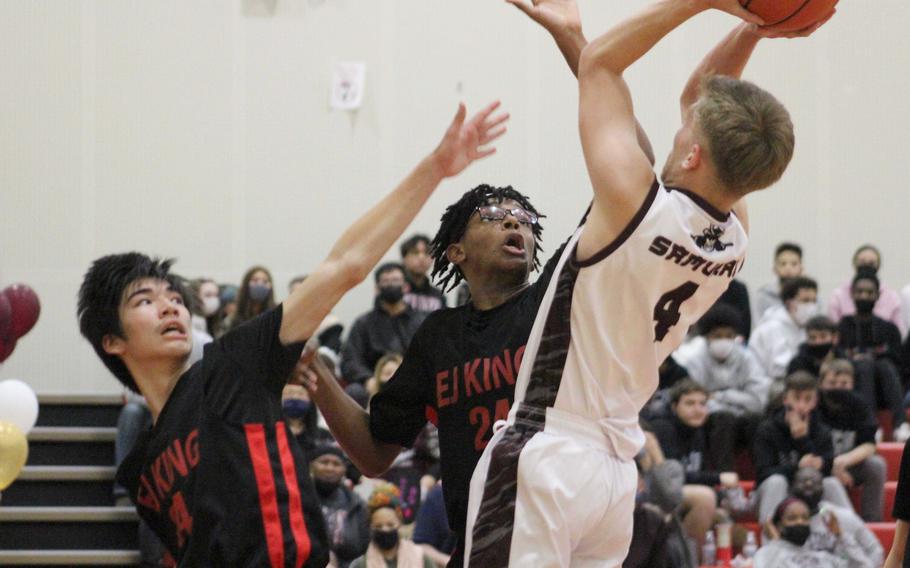 Matthew C. Perry's Ryan Livengood shoots over E.J. King's Nolan FitzGerald and Keith Lombard during Friday's DODEA-Japan boys basketball game. The Samurai won 50-31.