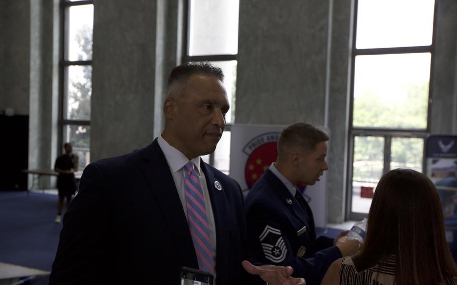 A man speaking in front of an enlisted officer.