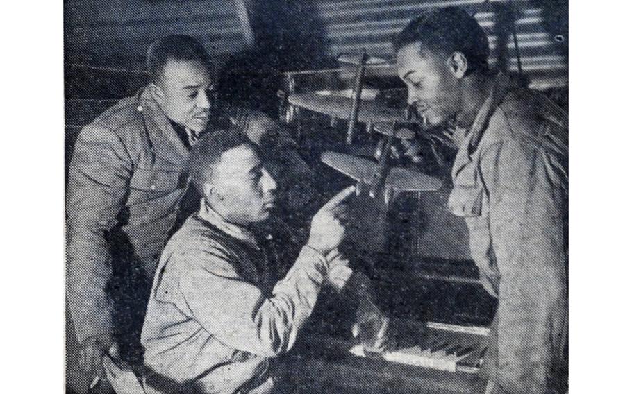 “They spend many hours, even during their off time, improving their ability at aircraft recognition,” read the original caption on this image, first published in the Northern Ireland edition of Stars and Stripes, Feb. 10, 1944. Three soldiers, part of an African American anti-aircraft battalion, study models of airplanes flown by the German Nazi enemy.