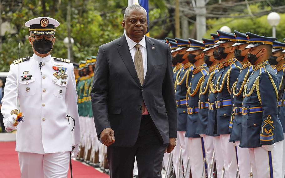 United States Defense Secretary Lloyd Austin, right, walks past military guards during arrival honors at the Department of National Defense in Camp Aguinaldo military camp on Feb. 2, 2023, in Quezon City, Manila, Philippines.  