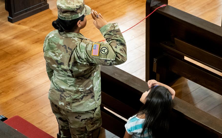 A U.S. service member salutes while the national anthem is played during a 9/11 memorial at Daenner Chapel in Kaiserslautern, Germany, on Sept. 10, 2021. 