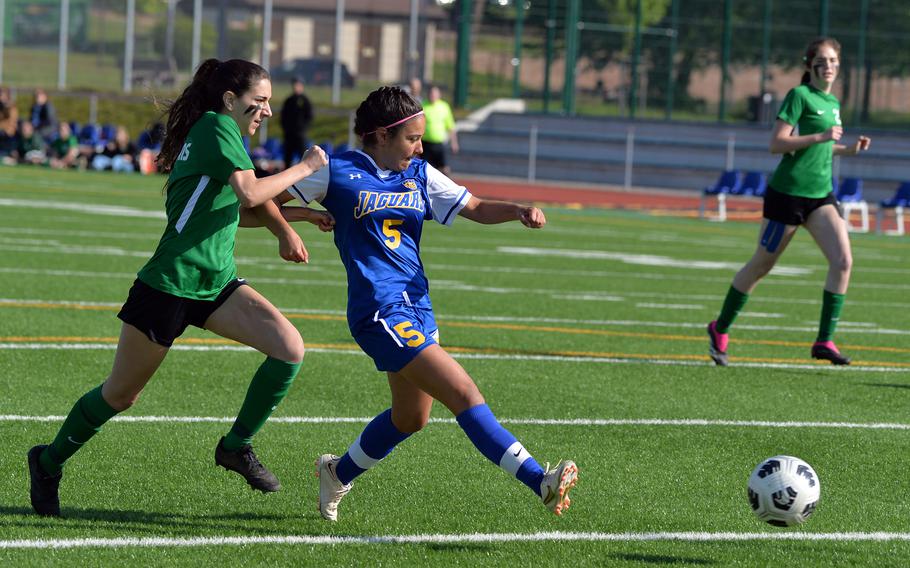 Sigonella’s Charlize Caro gets past Alconbury’s Kylie Leach to score the first goal of the game in the Jaguars’ 4-2 win over the Dragons in the girls Division III finals at the DODEA-Europe soccer finals in Ramstein, Germany, May 18, 2023.