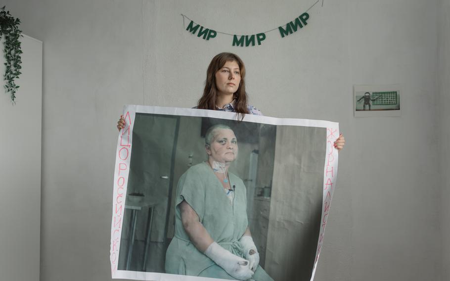 Yelizaveta Antonova holds the poster she and a friend made of Yelena Milashina, a reporter who was attacked in Chechnya. It reads: “The Face of Russian Journalism.” 