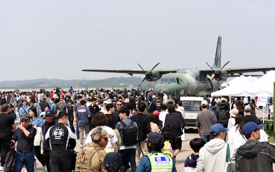 A crowd views a CN-235 transport plane during an airpower festival. 