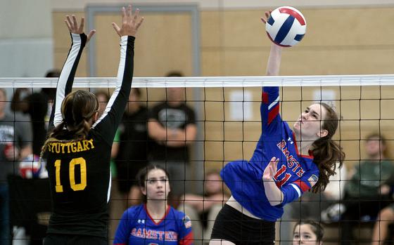 Royal outside hitter Kaitlyn Rex spikes the ball while Stuttgart's Laura Boom goes up to block during a scrimmage on Sept. 1, 2023, at Ramstein High School on Ramstein Air Base, Germany.