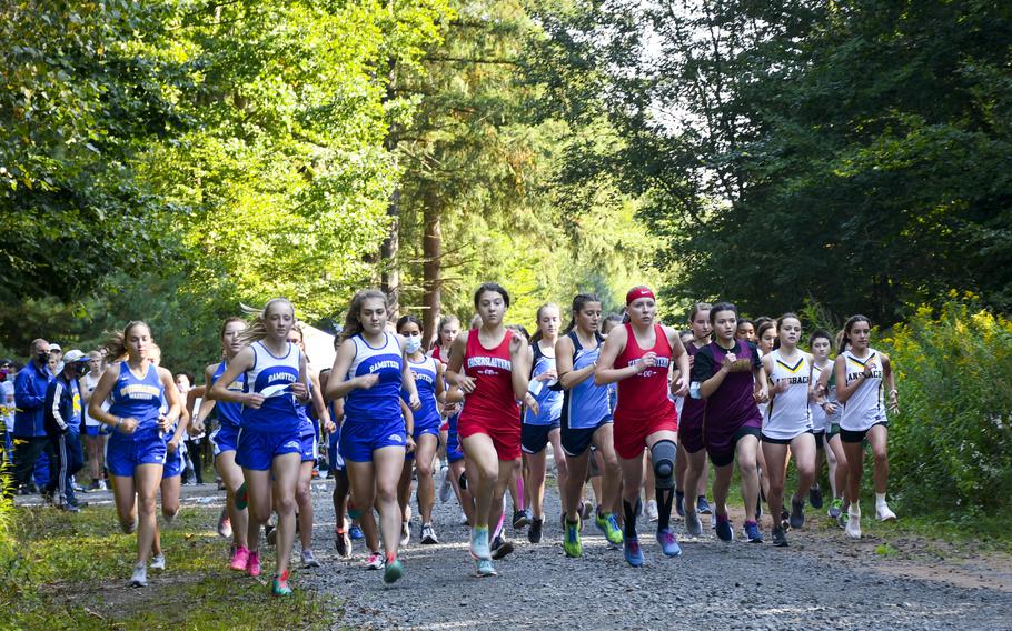 Runners take off at the beginning of a high school girls’ varsity cross country race Saturday, Sept. 18, 2021, in Kaiserslautern, Germany. 