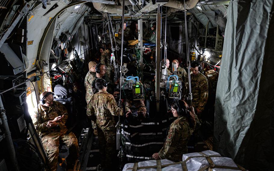 U.S. soldiers and airmen, alongside their Polish air force counterparts, provide care to mock casualties aboard an Air Force C-130 Hercules on June 6, 2023, over Romania. The teams simulated the challenges they may face while evacuating patients from the the battlefield.