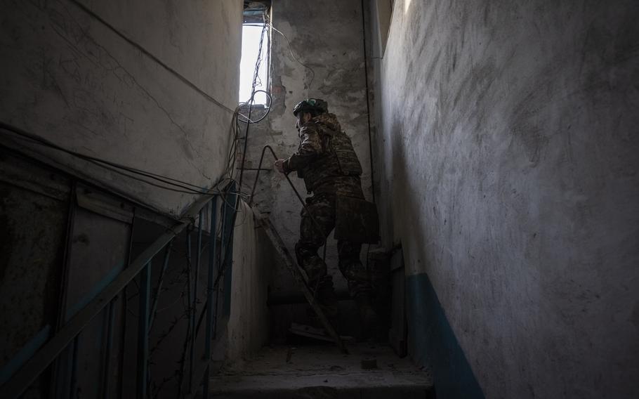 A soldier in Ukraine's 93rd Brigade goes to a position on the top of a destroyed building on April 18, 2023, in Bakhmut, Ukraine.