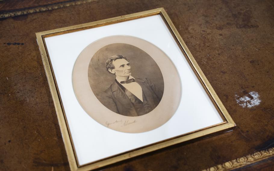 A sepia-toned portrait of Abraham Lincoln, which was signed by him and taken by Alexander Hesler, is on display.