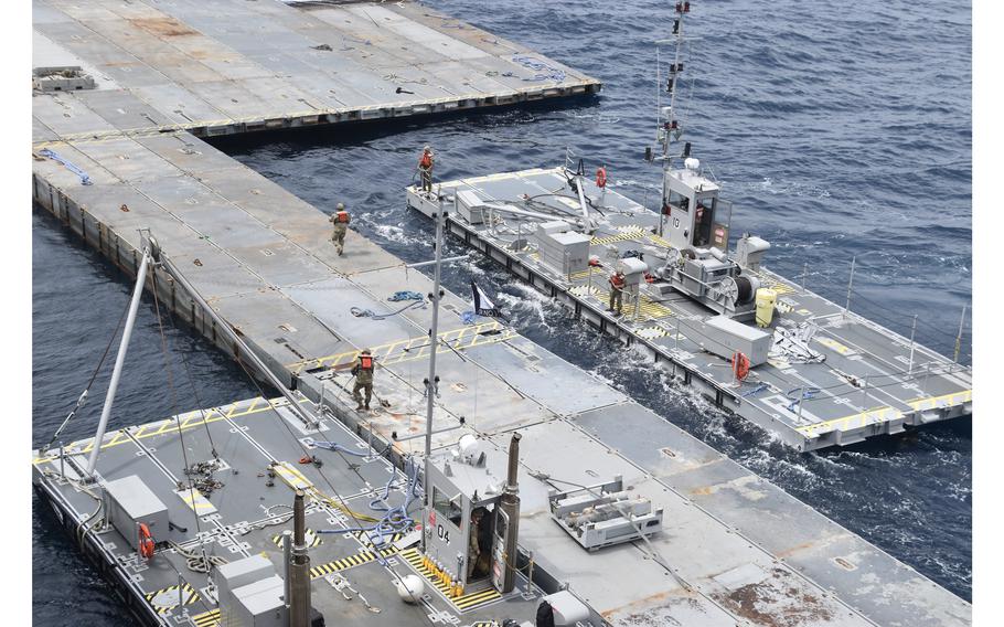 This undated photo released early Tuesday, April 30, 2024, by the U.S. military’s Central Command shows construction of a floating pier in the Mediterranean Sea off the Gaza Strip.