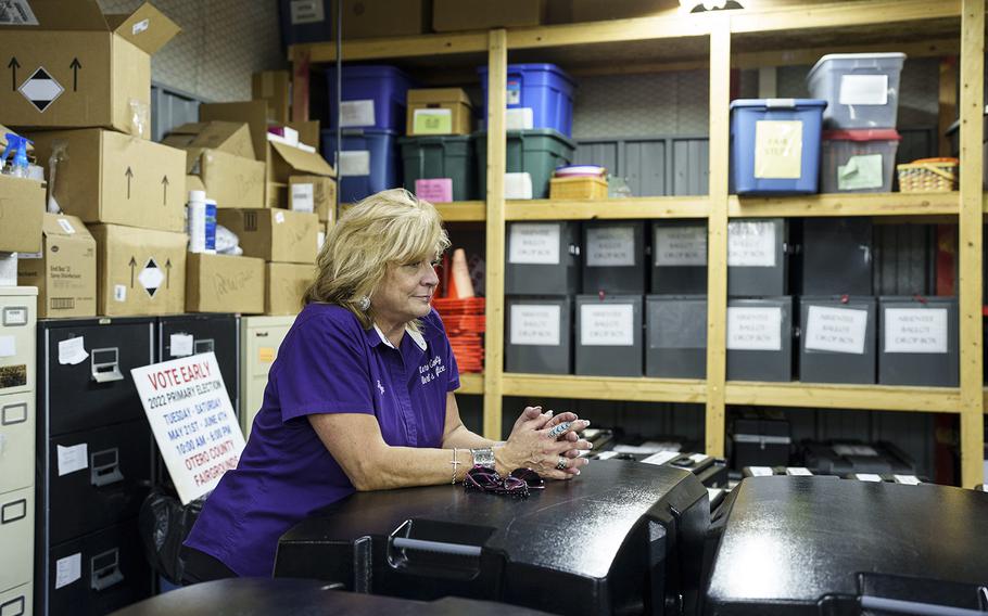 Otero County Clerk Robyn Holmes stands next to voting tabulators inside the county’s election storage facility in Alamogordo, N.M.