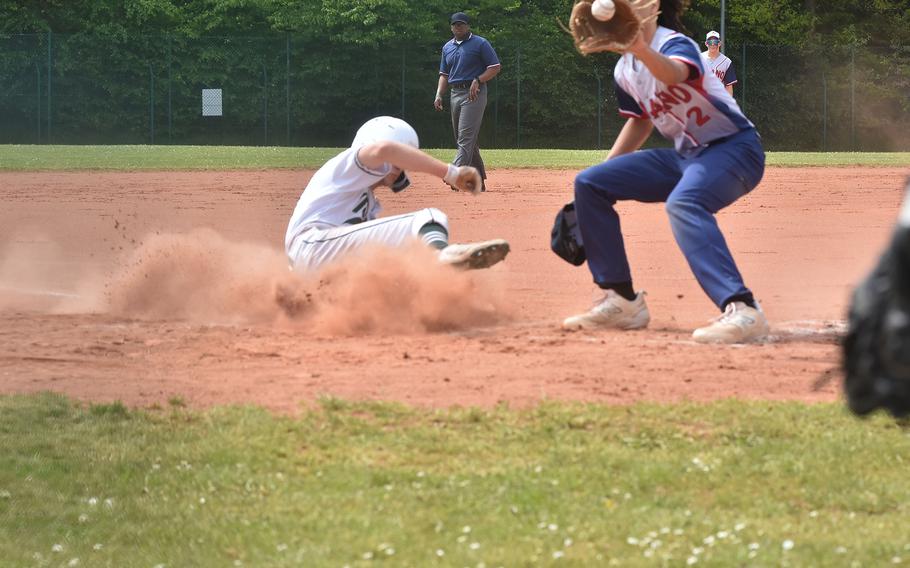 Naples’ Jonathan Vousboukis scores after a wild pitch Friday, May 19, 2023, before Aviano pitcher Sergio Melendez can apply the tag. The Wildcats advanced to the title game of the DODEA-Europe Division II/III baseball championships in Kaierslautern, Germany.