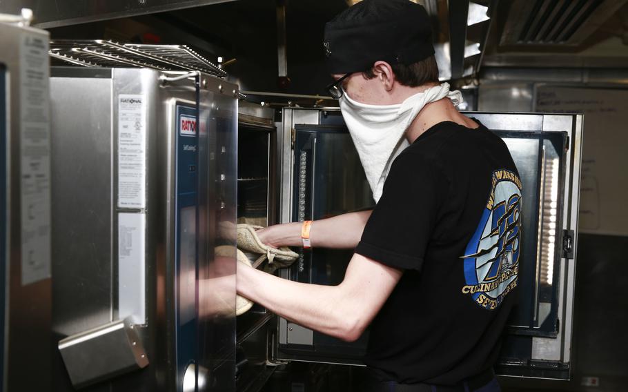 Petty Officer 3rd Class Andrew Weaver prepares food in USS Gerald R. Ford's conglomerate galley in 2020. Ford is the first aircraft carrier equipped with conglomerate galleys. 