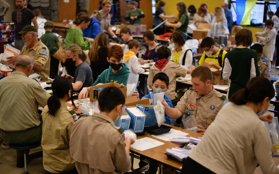 Volunteers compile emergency medical kits at Westland Middle School in Bethesda, Md., on March 19, 2022. 