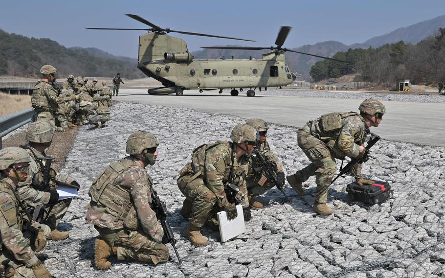 U.S. soldiers embark a CH-47 Chinook helicopter during a field artillery battalion gun raid drill at a military training field in Pocheon, South Korea, on March 19, 2023, as part of the Freedom Shield joint military exercise.