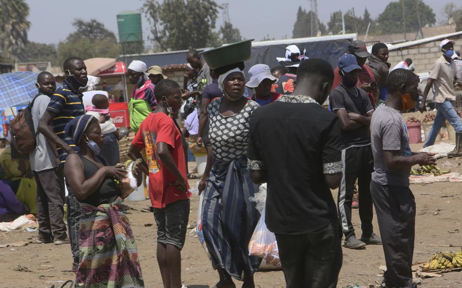 People are seen at a busy market on the outskirts of Harare, Zimbabwe, on Monday, Nov, 15, 2021.