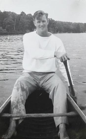 A man paddles a canoe