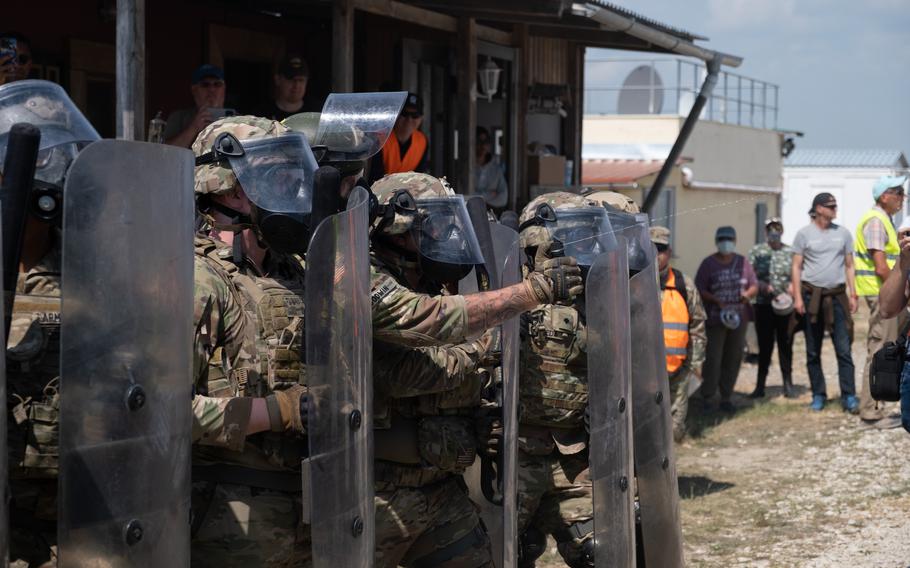 Riot control forces use spray to deter pretend protesters during the Operation Bronze Shield training exercise June 14, 2023, at the Joint Multinational Training Center in Hohenfels, Germany.