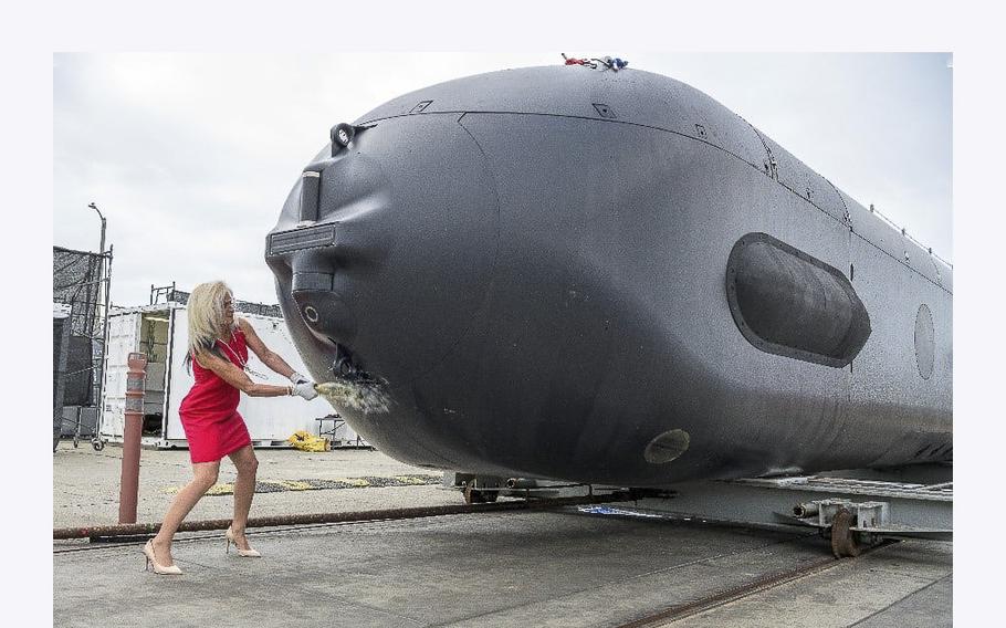 Dorothy Engelhardt, the director of Unmanned Systems, Deputy Assistant Secretary of the Navy (Ships), christens the Orca XLUUV Test Asset System during a ceremony April 28, 2022, in Huntington Beach, California. 