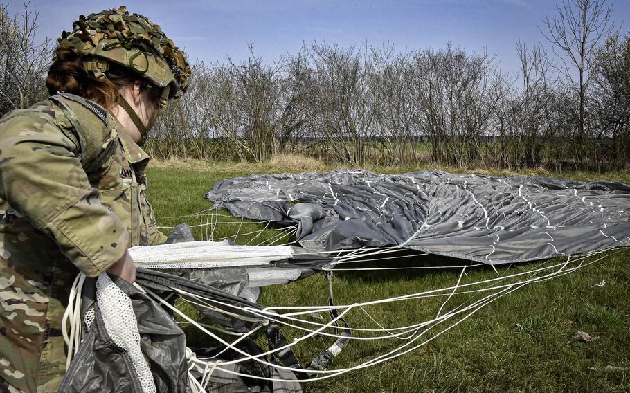 Army Sgt. Katherine Johnson, a member of the 1st Squadron, 91st Cavalry Regiment of the 173rd Airborne Brigade, gathers in her parachute following an all-female jump onto the Juliet Drop Zone near Vajont, Italy. It was Johnson's 20th jump.