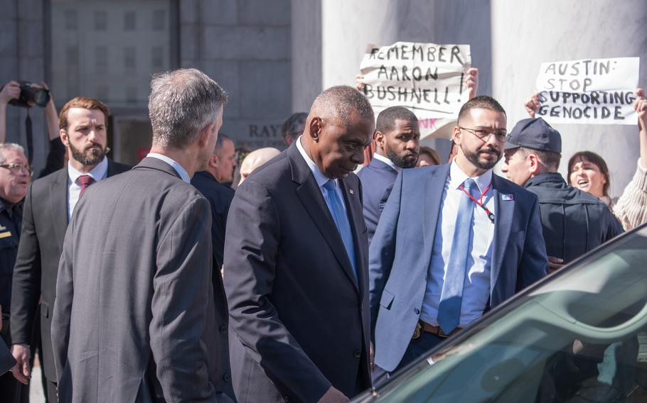 Defense Secretary Lloyd Austin walks past protesters as he leaves the Rayburn House office building on Thursday, Feb. 29, 2024, after testifying at a House Armed Services Committee hearing on Capitol Hill in Washington, D.C.
