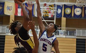 Vilseck's Barkale Johnson puts up a shot over the outstretched hands of Ramstein's Ky'Ron Hall in a Diviision I semifinal game Friday, Feb. 16, 2024, at the DODEA European Basketball Championships.

Kent Harris/Stars and Stripes