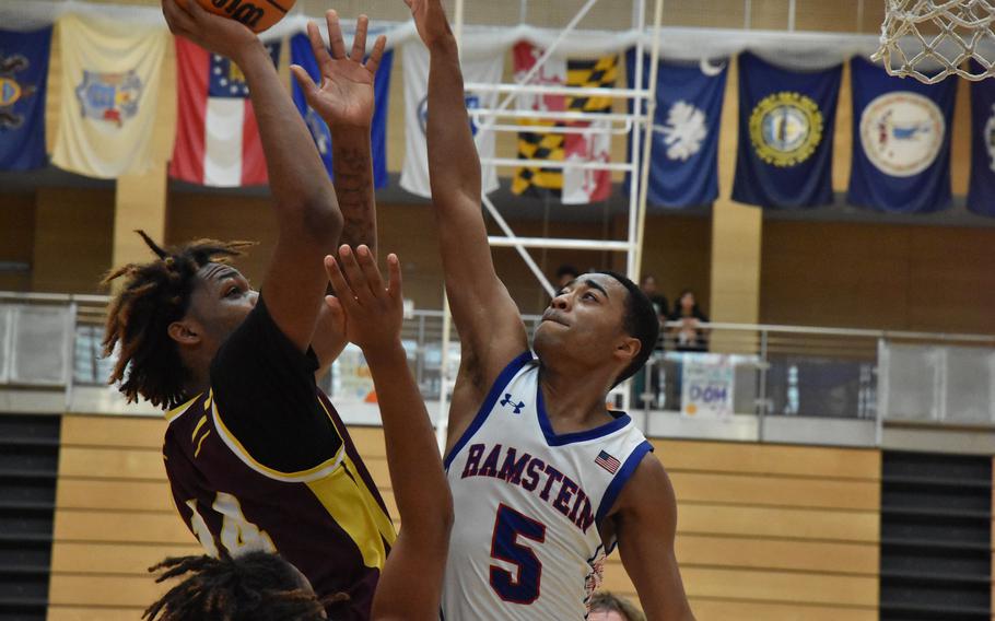 Vilseck’s Barkale Johnson puts up a shot over the outstretched hands of Ramstein’s Ky’Ron Hall in a Diviision I semifinal game Friday, Feb. 16, 2024, at the DODEA European Basketball Championships.