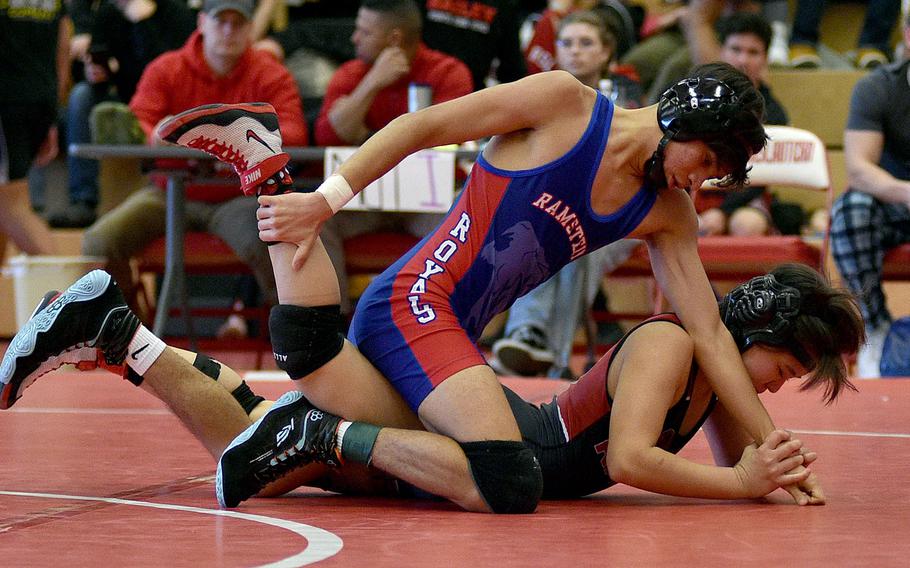 Ramstein's Frank Lozano and Kaiserslautern's Uno Tate grapple during a 113-pound semifinal match at a wrestling meet on Jan. 27, 2024, at Kaiserslautern High School in Kaiserslautern, Germany.