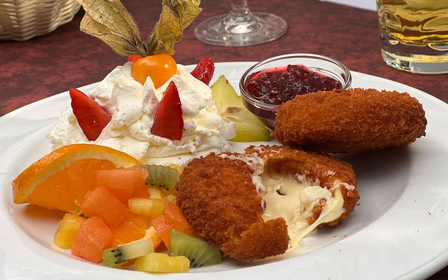 The baked sheep’s milk cheese with hazelnut breading served with cranberry sauce and fruit at the Duerkheim Giant Barrel in Bad Duerkheim, Germany. The hearty cheese blends well with the sweet whipped cream and fruit flavors, creating a satisfying dessert or refreshing standalone dish in the summer. 