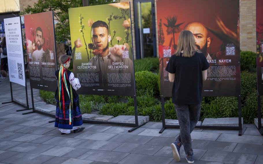 Ukrainians in Kyiv look at boards displaying photographs of Ukrainian soldiers who have suffered severe injures during the war with Russia on April 28, 2024.