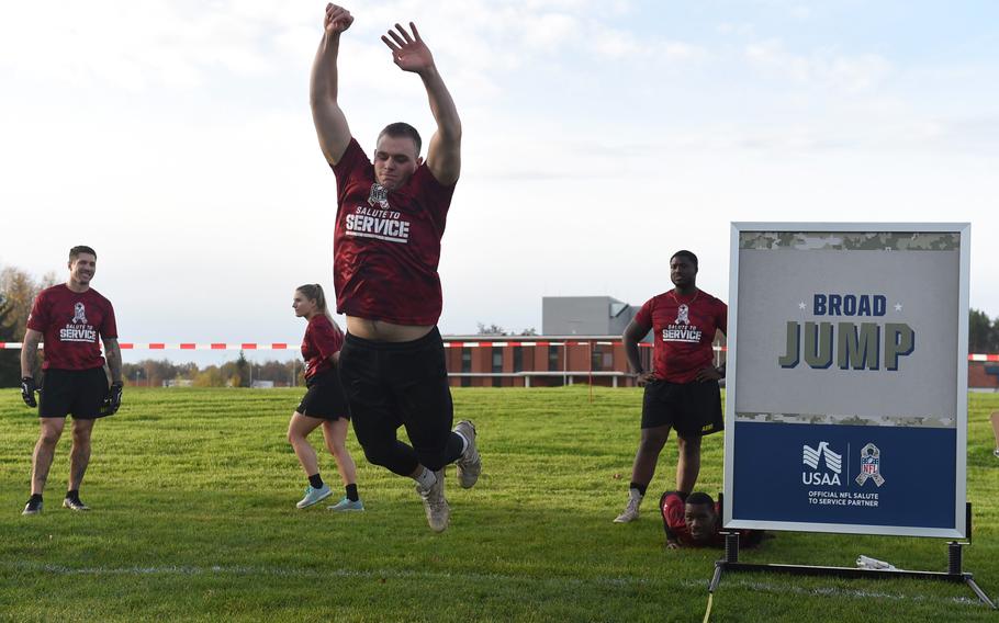 Soldiers participate in the broad jump event at the NFL Salute to Service boot camp at Vilseck, Germany, Nov. 9, 2022.