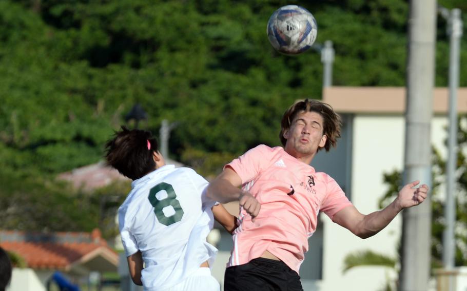 Kadena's Joey Puterbaugh and Kubasaki's Frank Stare go up to head the ball during Wednesday's DODEA-Okinawa boys soccer match. The teams battled to a scoreless tie.